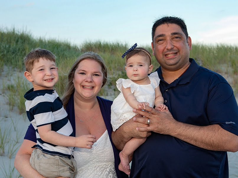 Family photo of toddler boy with eczema, Mom, infant girl and Dad